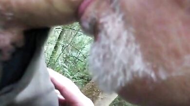 Pompino all'aperto tra papà maturo e amico orso