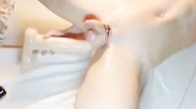 Twink oliato si masturba con un dildo gigante